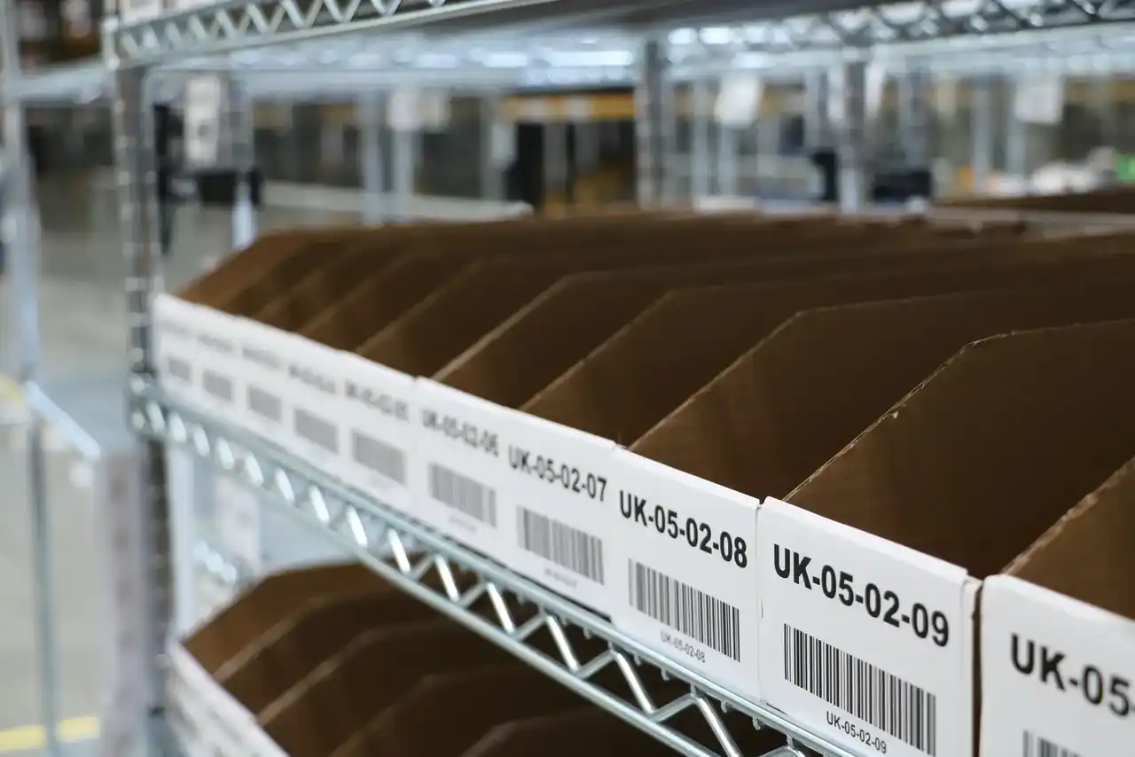 Labeled picking bins on warehouse shelving